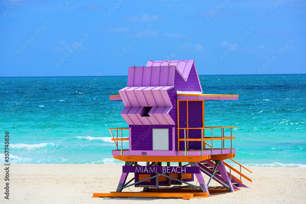 Fototapeta premium Miami South Beach skyline. Lifeguard tower in colorful Art Deco style and Atlantic Ocean at sunshine. World famous travel location.