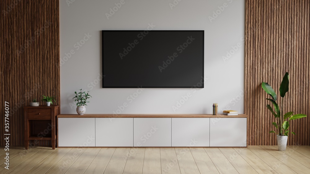 Large TV on the wall. The white room on the side decorated with wood, with trees and books on the table.3D Rendering. Large TV on the wall. The white room on the side decorated with wood, with trees and books on the table.3D Rendering.
