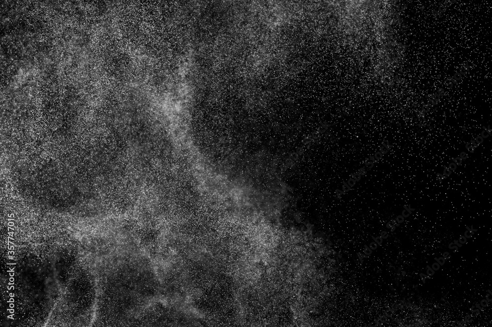 Abstract splashes of water on black background. Freeze motion of white particles. Rain, snow overlay texture. Abstract splashes of water on black background. Freeze motion of white particles. Rain, snow overlay texture.