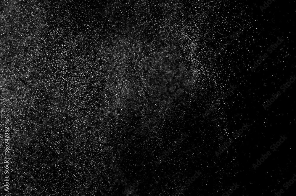 Abstract splashes of water on black background. Freeze motion of white particles. Rain, snow overlay texture. Abstract splashes of water on black background. Freeze motion of white particles. Rain, snow overlay texture.