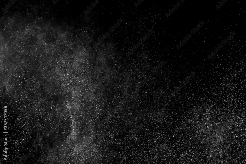 Abstract splashes of water on black background. Freeze motion of white particles. Rain, snow overlay texture. Abstract splashes of water on black background. Freeze motion of white particles. Rain, snow overlay texture.