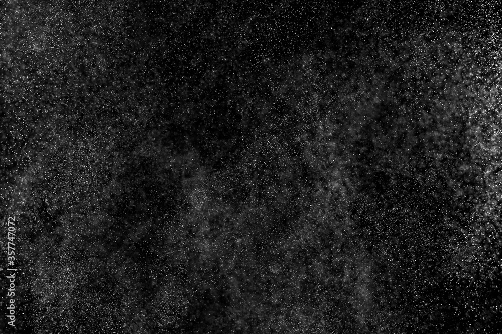 Fototapeta premium Abstract splashes of water on black background. Freeze motion of white particles. Rain, snow overlay texture.