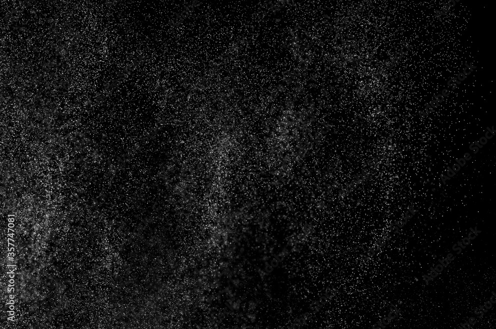 Fototapeta premium Abstract splashes of water on black background. Freeze motion of white particles. Rain, snow overlay texture.