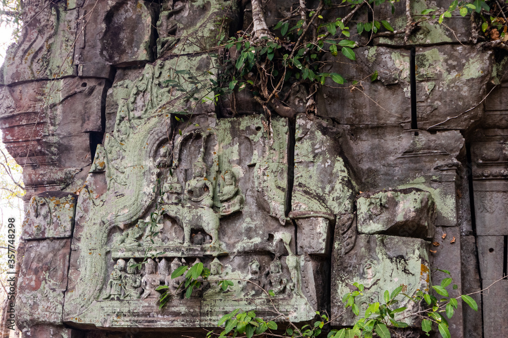 Deatail of carved stone among the ruins at Beng Mealea (meaning: lotus pond) ancient temple with plants growing between stones. Easter part of the Angkor region, Siem Reap, Cambodia, South east Asia