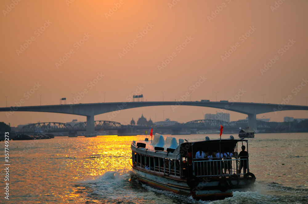A Ferry on a River at Sunset