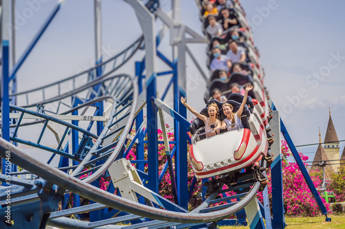 Fotografie, Tablou Happy friends in amusement park on a summer day