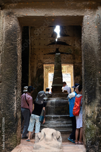 Angkor temples, Siem Reap, Cambodia, South east Asia; February 2020: Tourists visiting Preah Khan temple, representation of a lingam phallus in one of the galleries