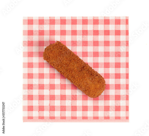 Brown crusty dutch kroket on a red napkin isolated