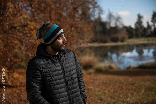 Brown man standing in front of tree in fall © Santiago