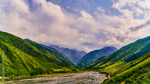 Panorama of a mountain valley in the summer. A fabulous mountain view of the peaks, amazing nature, summer in the mountains. Travel, tourism. beautiful background picture of nature © Юрий Кузнецов