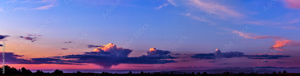 Bright sunlight through the clouds against a breathtaking evening sky at sunset. panorama, natural composition