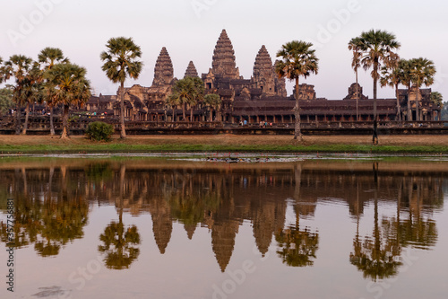 Cambodia  Feb 2020: Facade of Angkor wat temple reflected on the water at sunset time, pink atmosphere. The largest religious monument in the world. Angkor wat, Siem Reap, Cambodia © Alba