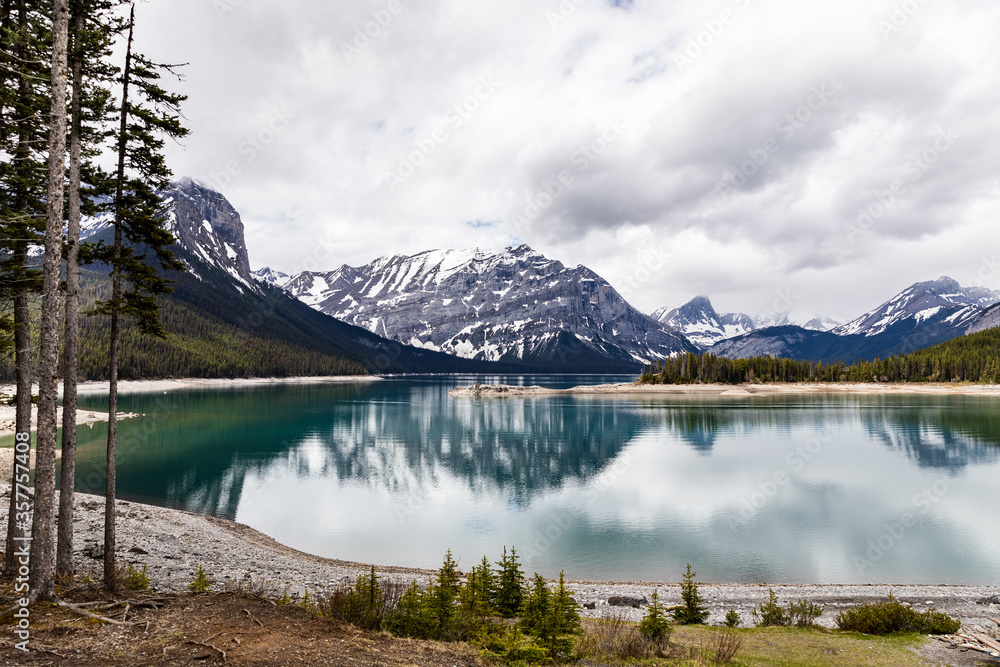 Landscape view of a mountain lake with turquoise water and mountains in the background. Canada, Alberta. Upper Kananaskis Lake.