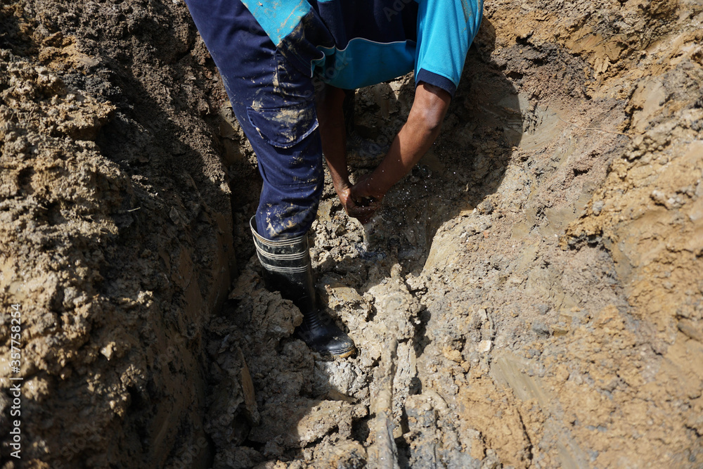 HDPE pipe leaking on ferrule connection is being repaired HDPE pipe leaking on ferrule connection is being repaired