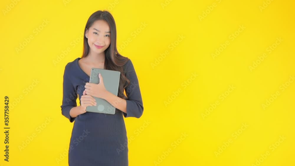 A well-dressed woman holding an iPad close against her body. Copy space A well-dressed woman holding an iPad close against her body. Copy space