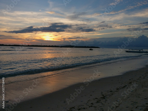 blue sky orange sunset view of sunshine and cloud in calm sea with warm sun bright twilight