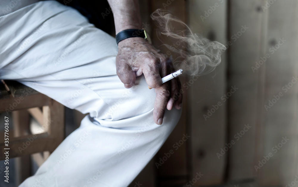 Cigarette damage caused by nicotine-addicted old man