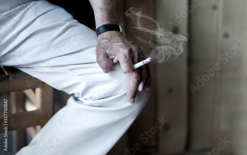 Cigarette damage caused by nicotine-addicted old man
