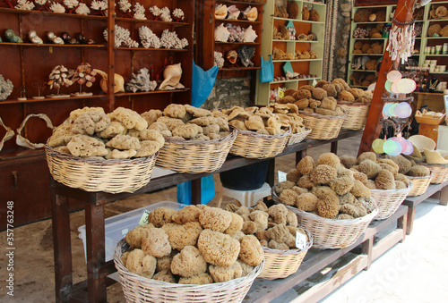Sea sponges of different shapes and sizes sold at a small shop in Symi town, Symi island, Greece
