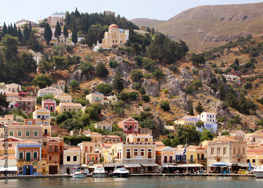 Symi town, Symi island, pictorial view of colorful houses and the harbour
