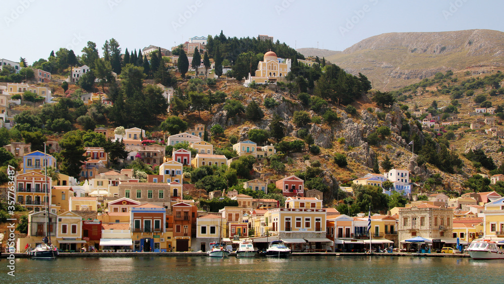 Symi town, Symi island, pictorial view of colorful houses and the harbour
