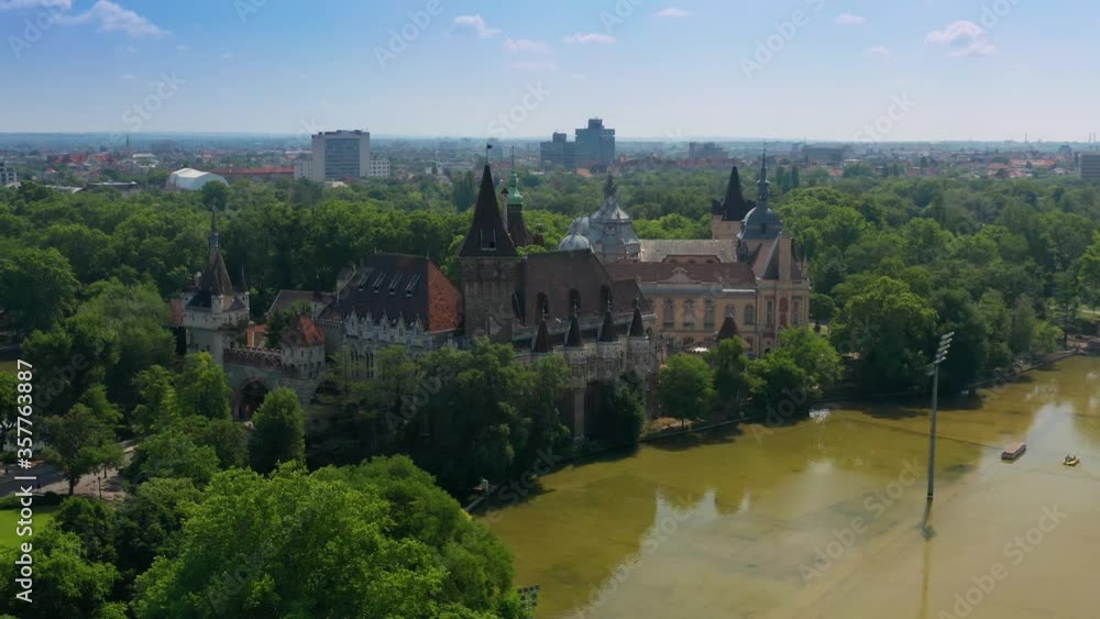 Budapest, Hungary - 4K aerial view of Vajdahunyad Castle in City Park (Varosliget) and City Park Lake on a sunny summer day with clear blue sky Budapest, Hungary - 4K aerial view of Vajdahunyad Castle in City Park (Varosliget) and City Park Lake on a sunny summer day with clear blue sky