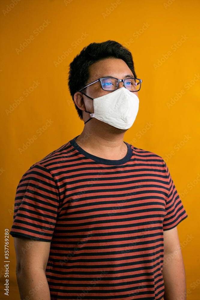 Covid-19 Coronvavirus.Working from home concept.Asian man wearing face mask. Pandemic virus symptoms. Covid-19 Coronvavirus.Working from home concept.Asian man wearing face mask. Pandemic virus symptoms.