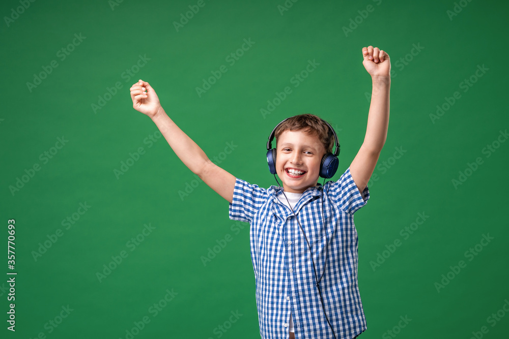 Enjoying song playing in headphones. Little boy do vocal on song, big music fan.