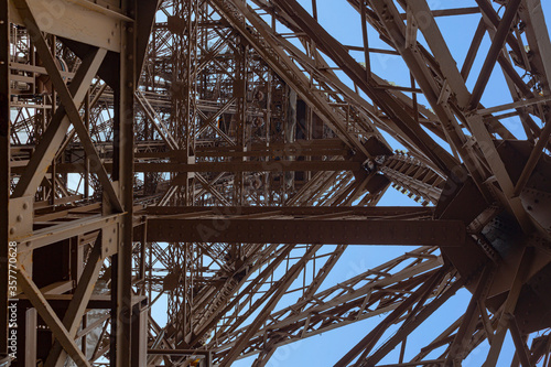 Inner up view of the Eiffel tower structure against a pur blue sky, Paris, France