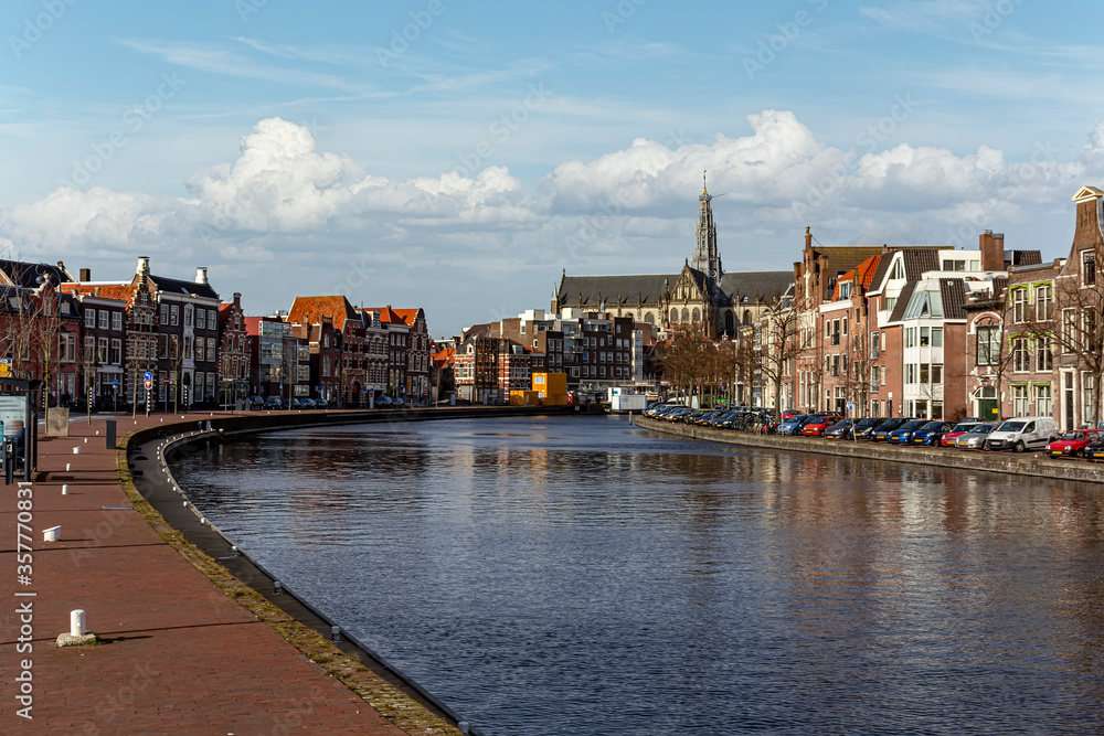 Canal view on the Haarlem and Bavo church at the center city skyline along the canal, Netherlands