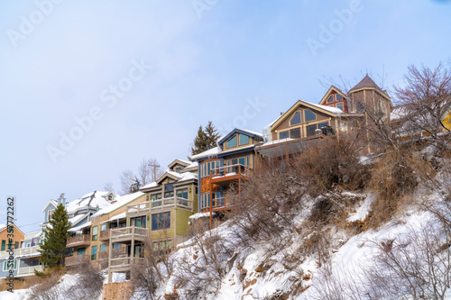 Homes with snowy roofs and balconies in scenic Park City Utah neighborhood © Jason