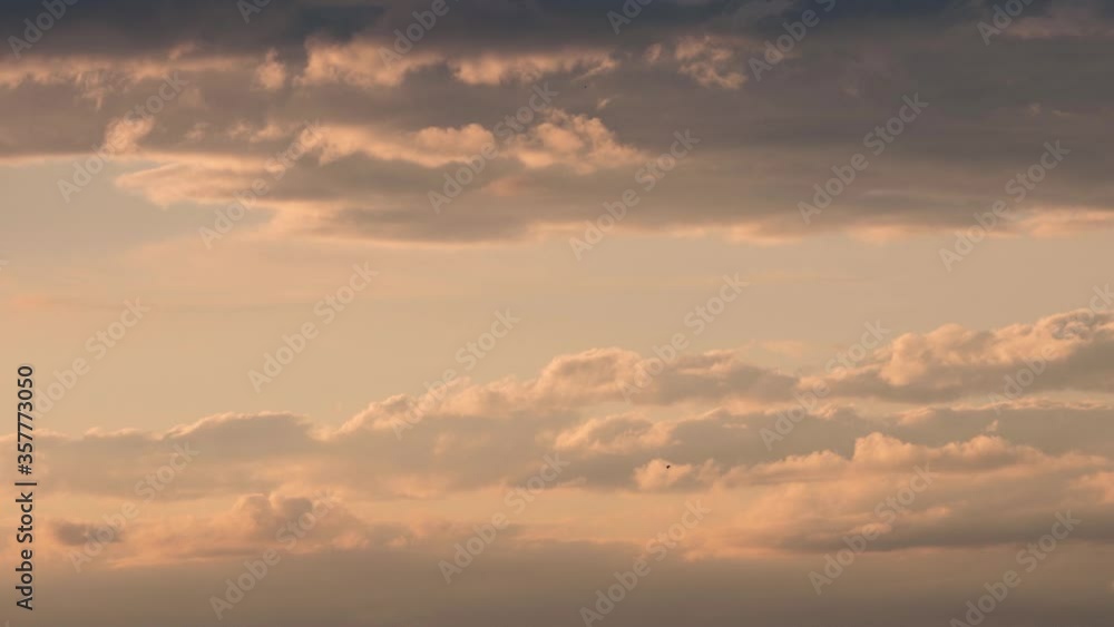 dark clouds float across the sky in the evening in different directions dark clouds float across the sky in the evening in different directions