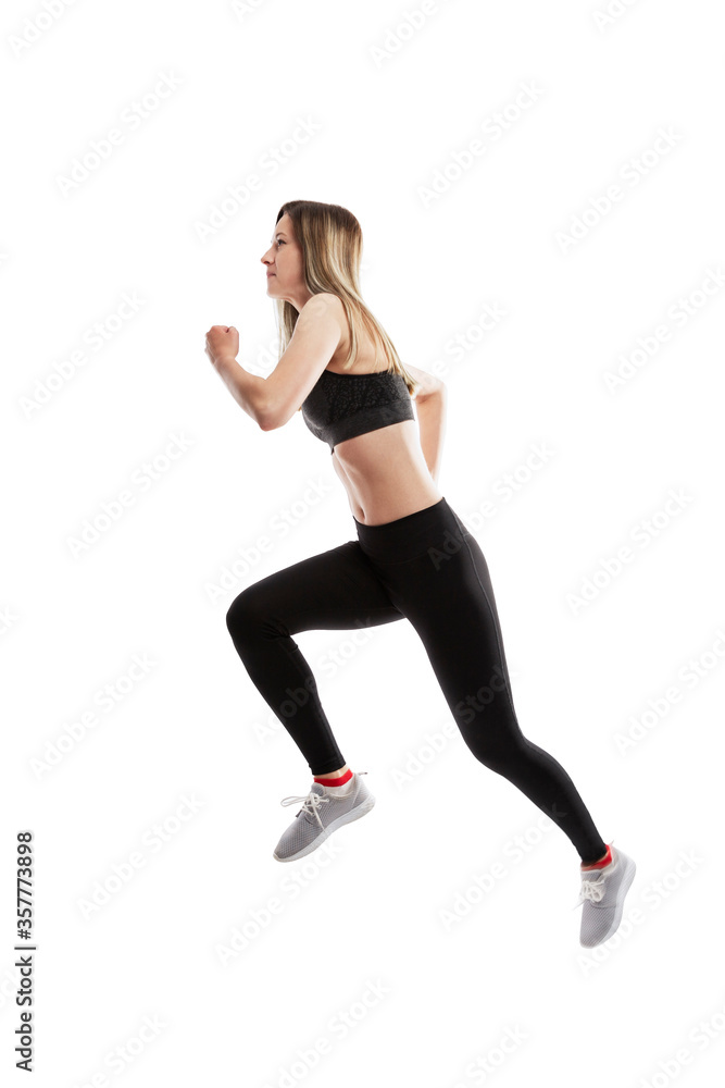 Running young girl in sportswear. Side view. Movement, sport and health. Isolated on a white background. Vertical. Running young girl in sportswear. Side view. Movement, sport and health. Isolated on a white background. Vertical.