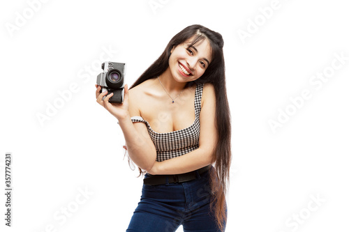 Laughing young girl with a camera in her hands. Brunette with long hair. Art and hobbies. Isolated on a white background.