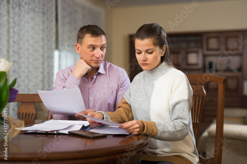 Man and woman sitting at the table reading documents