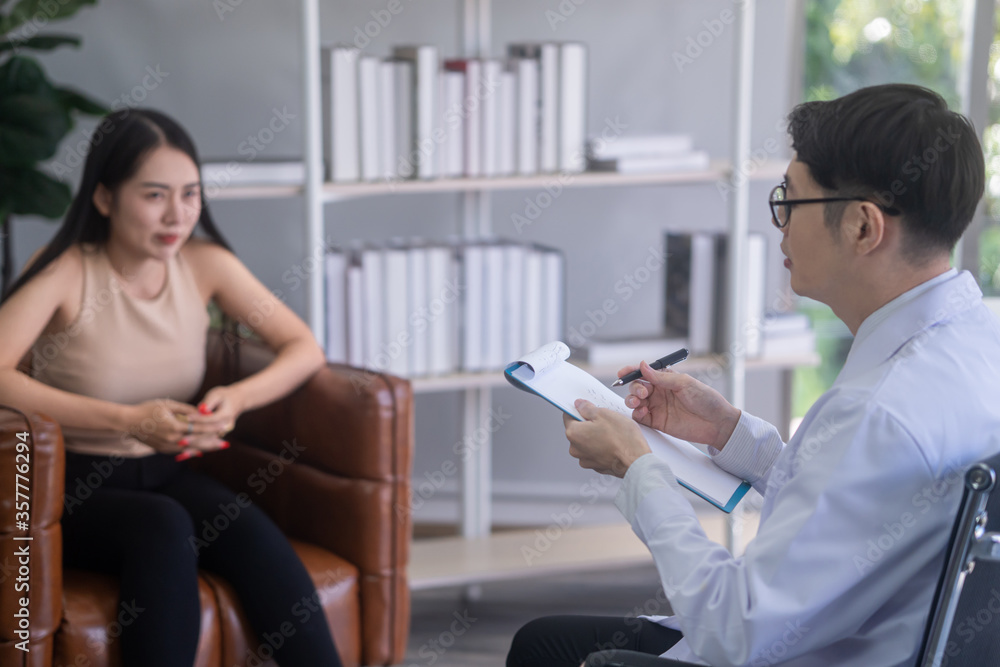 The psychiatrist is advising stressful asian female patients. The psychiatrist is advising stressful asian female patients.