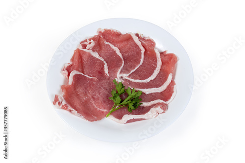 Tenderized boneless raw pork chops on the white dish