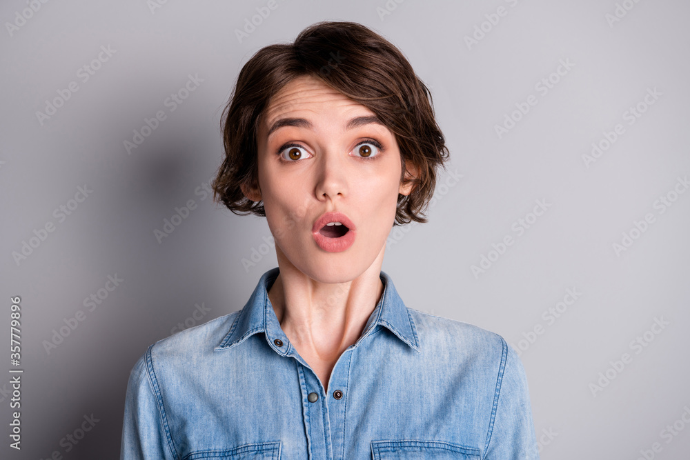 Closeup photo of attractive shocked lady wavy bobbed hairdo open mouth watch news corona virus infection spreading wear casual denim shirt isolated grey color background Closeup photo of attractive shocked lady wavy bobbed hairdo open mouth watch news corona virus infection spreading wear casual denim shirt isolated grey color background