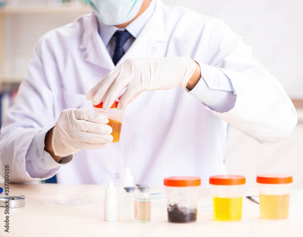 Young handsome chemist working in the lab Young handsome chemist working in the lab