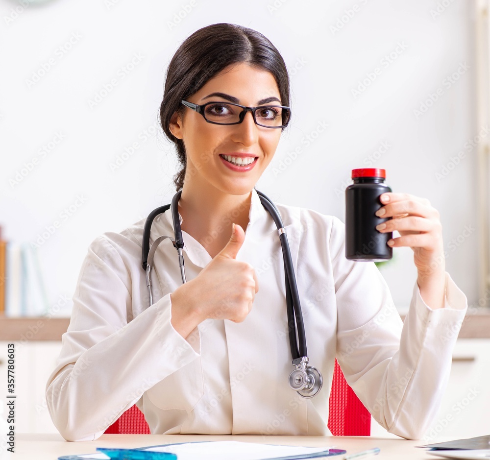 Woman doctor with bottle of medicines Woman doctor with bottle of medicines