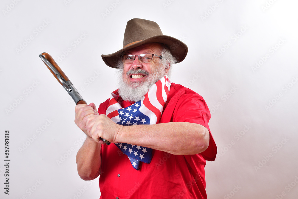 West Texas rancher is swining his short rifle like a bat..Angry old man  dressed for the 4th of july is swinging his rifle like a bat. Stock Photo |  Adobe Stock