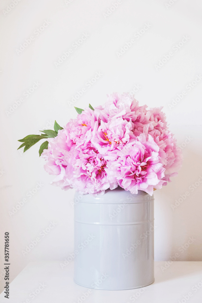 Obraz premium Beautiful bouquet of fresh pink peony flowers in full bloom in vase.