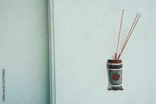 Photography small chinese altar with incense sticks on a wall in Kuala Lumpur