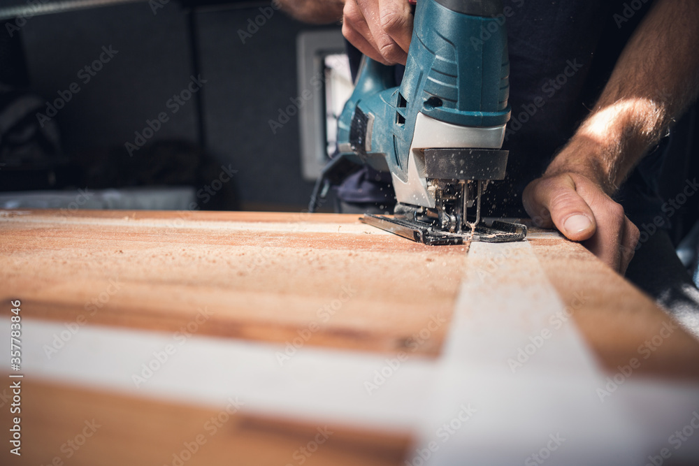 Jigsaw in action on a wooden countertop Jigsaw in action on a wooden countertop