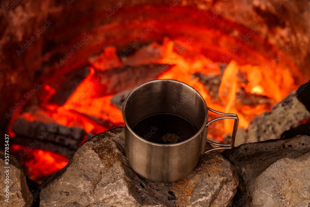 Cooking black coffee on a campfire. Cooking black coffee on a campfire.