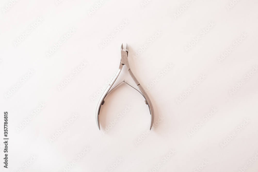 manicure tongs on a white background. nail clippers. Top view. Mock up. Flat lay composition. manicure tongs on a white background. nail clippers. Top view. Mock up. Flat lay composition.