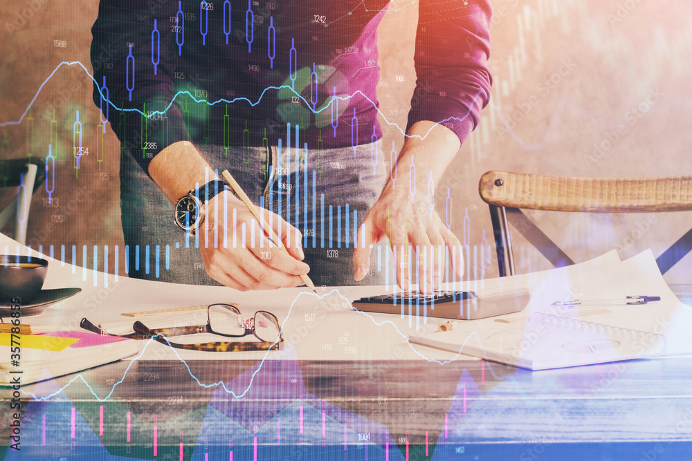 Multi exposure of man standing and planing investment with stock market forex chart.