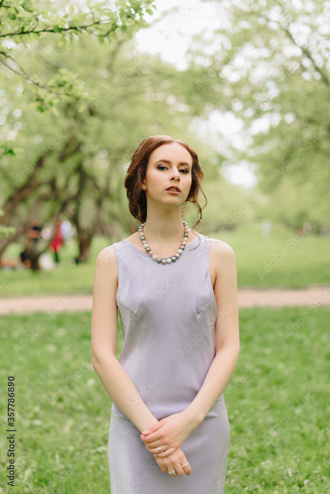 portrait of a beautiful young thin white girl against the background of a summer Park portrait of a beautiful young thin white girl against the background of a summer Park