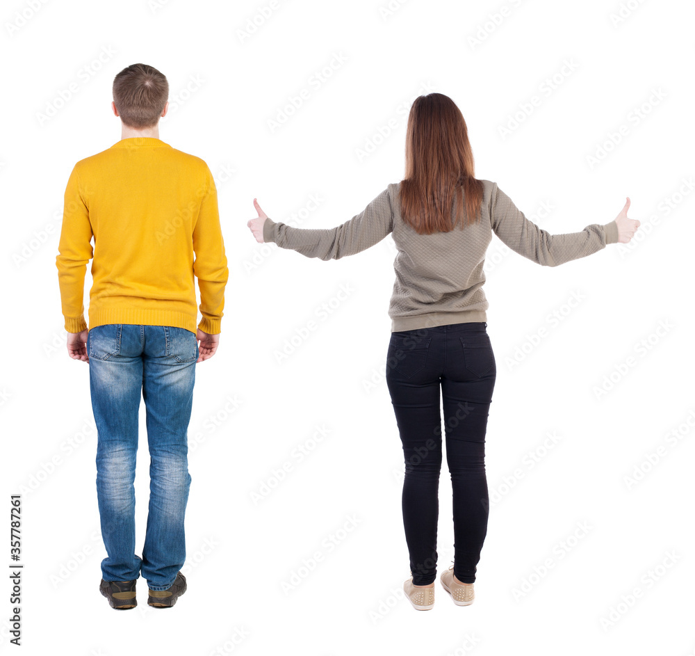 Back view of couple in sweater showing thumbs up. Back view of couple in sweater showing thumbs up.
