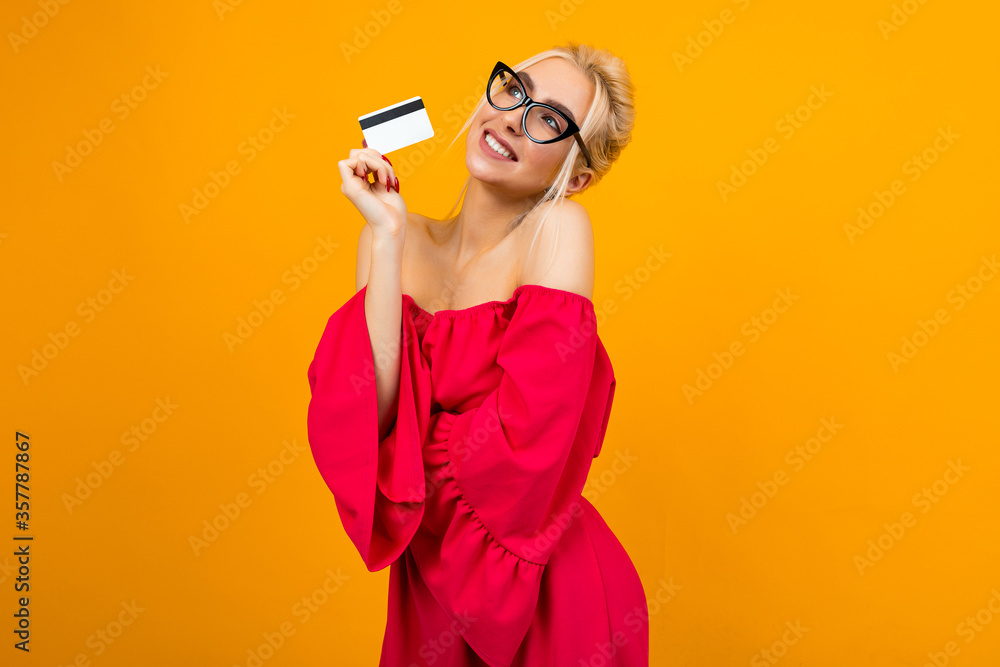 portrait of a girl with a card with a mockup for shopping on a yellow background portrait of a girl with a card with a mockup for shopping on a yellow background